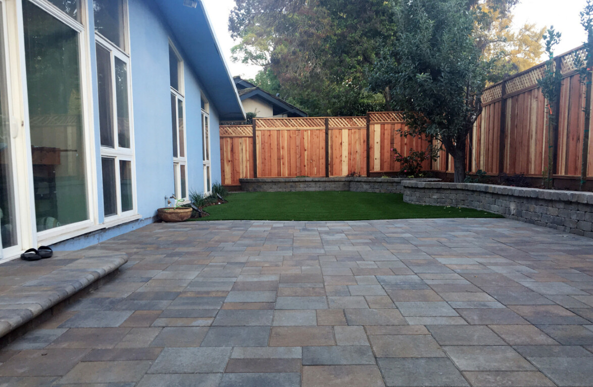 Beautiful concrete patio installation with retaining wall in Montebello