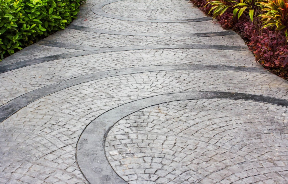 Decorative stamped concrete walkway with elegant circular pattern design